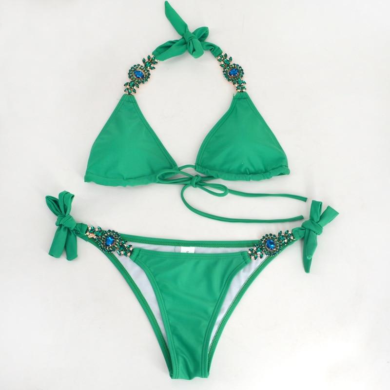 Green bikini with decorative jewels.