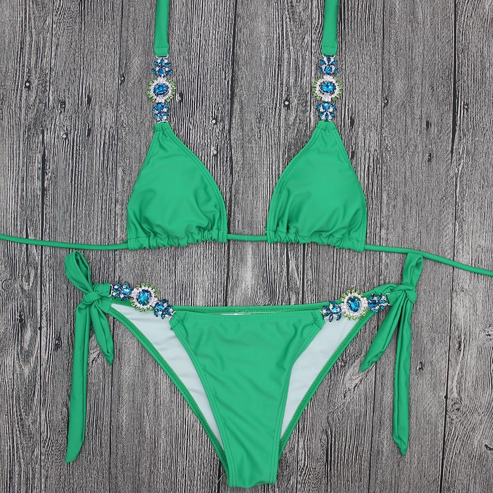 Green bikini with decorative gems.