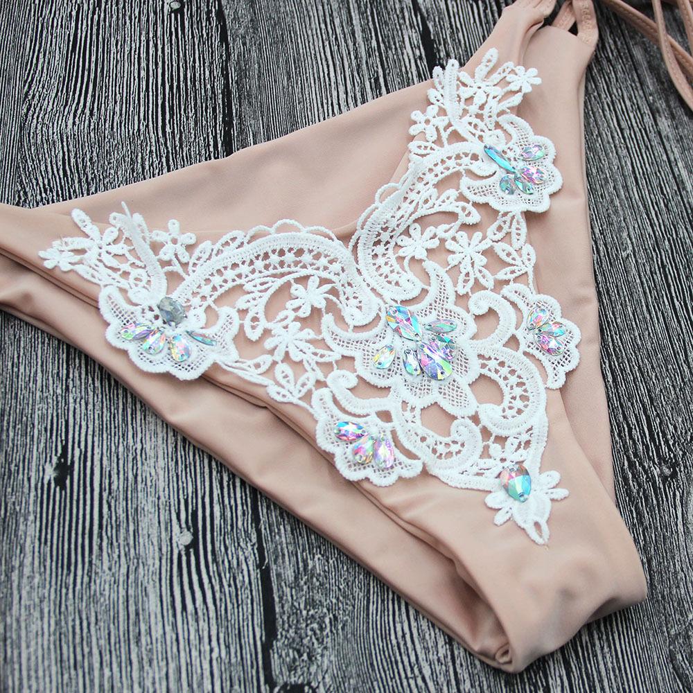 Beige bikini bottom with lace.