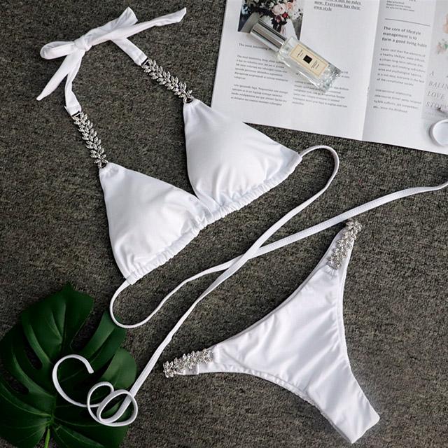 White bikini with decorative details.