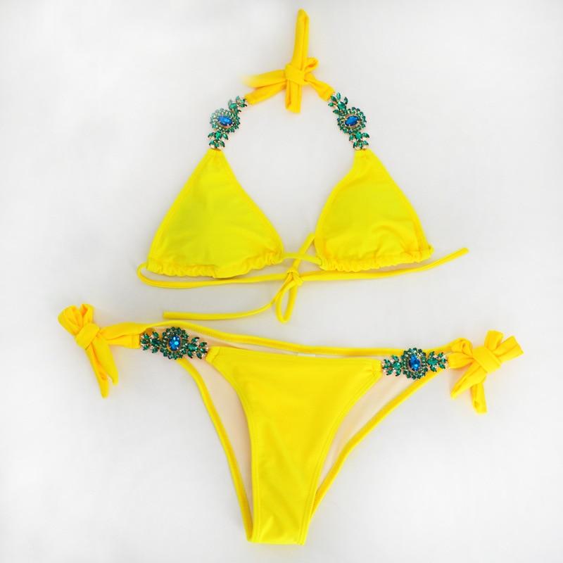 Yellow bikini with gemstone embellishments.