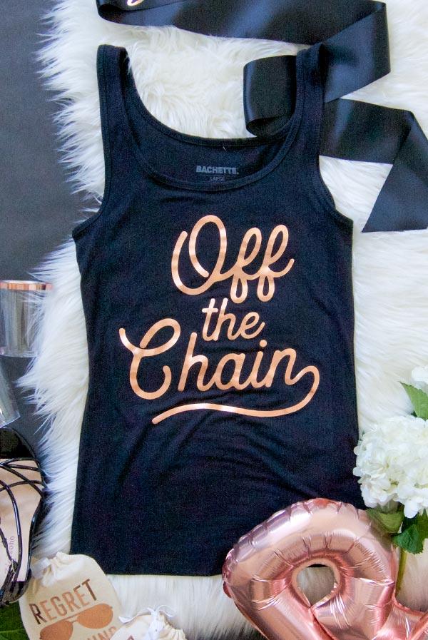 A stylish white tank top with rose gold foil text reading 'Off the Market', showcasing a trendy design perfect for casual outings.