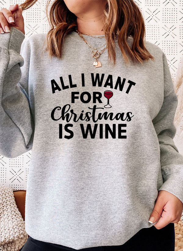 Cozy 'All I Want For Christmas Is Wine' sweatshirt featuring festive design and adjustable cuffs, perfect for winter wear.