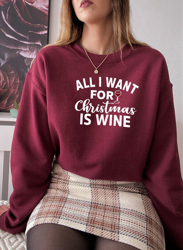 Cozy 'All I Want For Christmas Is Wine' sweatshirt featuring festive design and adjustable cuffs, perfect for winter wear.