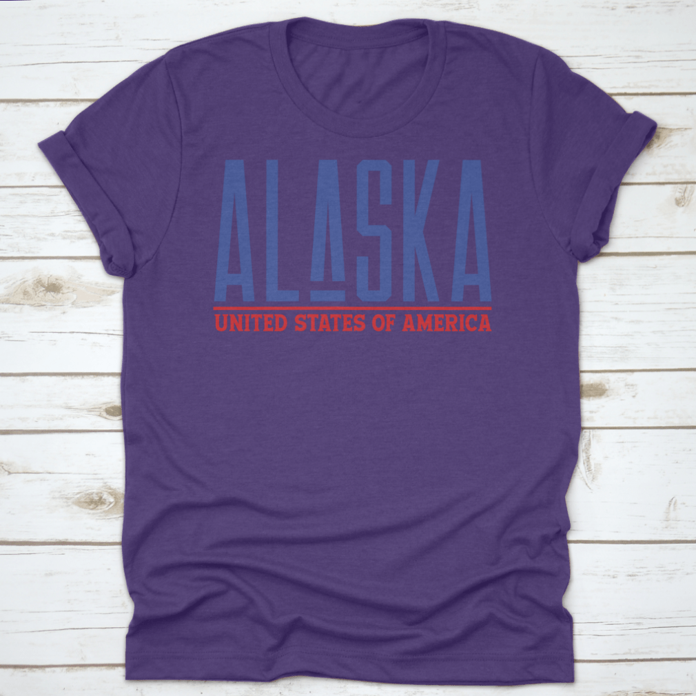 Alaska Modern Name Vector Graphic Shirt displayed on a hanger, showcasing its unique design and quality fabric.