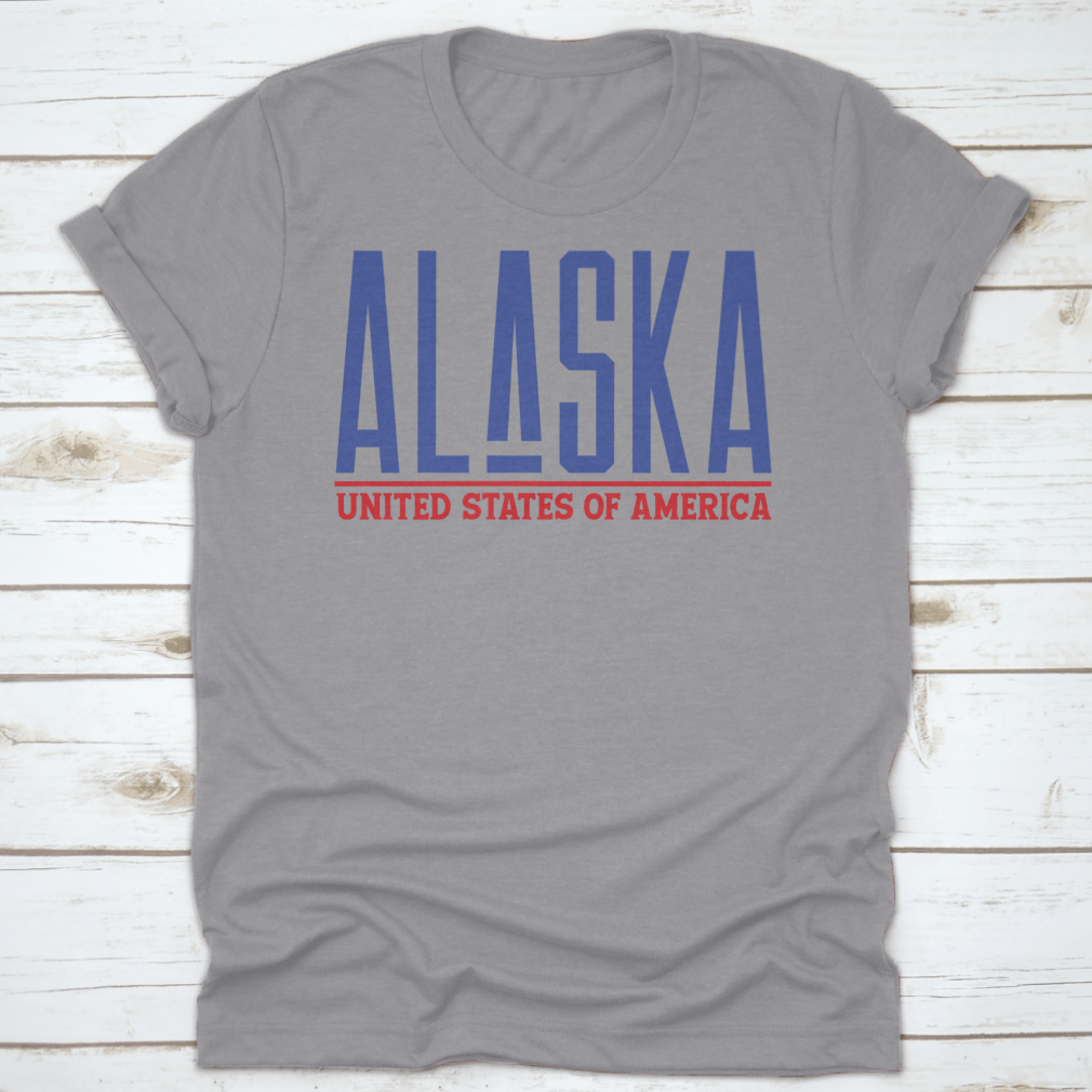 Alaska Modern Name Vector Graphic Shirt displayed on a hanger, showcasing its unique design and quality fabric.