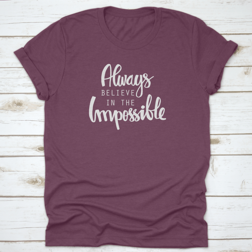 A motivational T-shirt featuring the quote 'Always Believe In The Impossible' in a stylish design, made from soft cotton fabric.