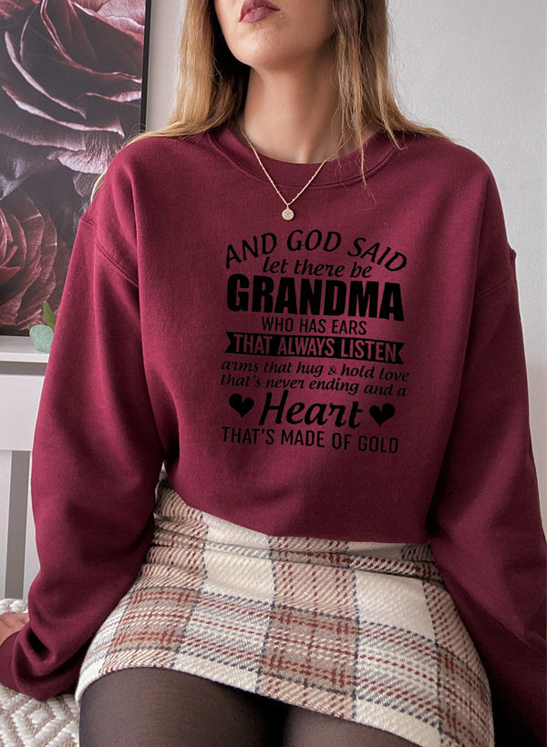 Cozy sweatshirt featuring the phrase 'And God Said Let There Be Grandma', made from a soft cotton/poly fleece blend.