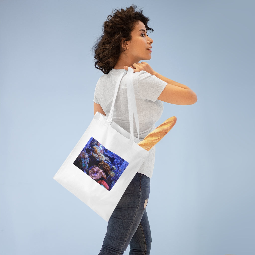 A colorful Aquarium Tote Bag made of 100% cotton with long handles and cross stitching for added stability, perfect for carrying various items.