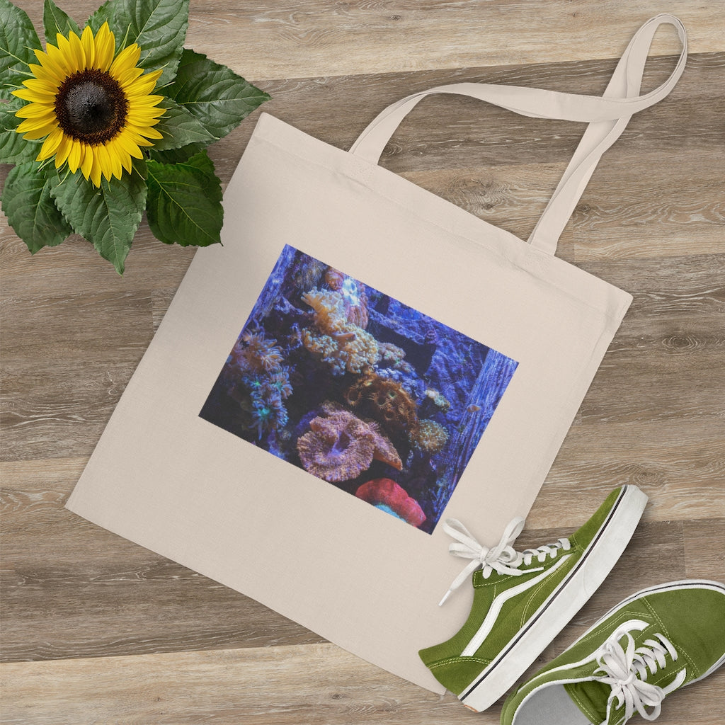 A colorful Aquarium Tote Bag made of 100% cotton with long handles and cross stitching for added stability, perfect for carrying various items.