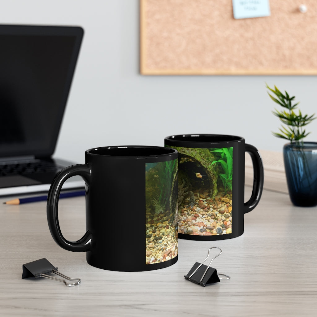 A sleek black ceramic mug with a C-handle, perfect for coffee, tea, or hot chocolate, showcasing its elegant design.