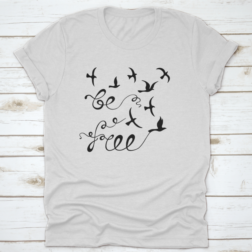 A stylish Be Free Inspirational Quote shirt featuring modern calligraphy on a soft cotton fabric, perfect for casual wear.