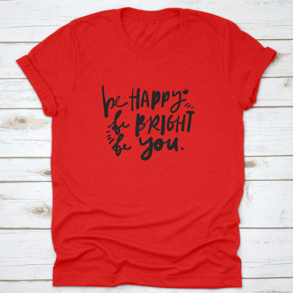 A stylish cotton apparel featuring the quote 'Be Happy, Be Bright, Be You' in hand lettering, perfect for skincare enthusiasts.