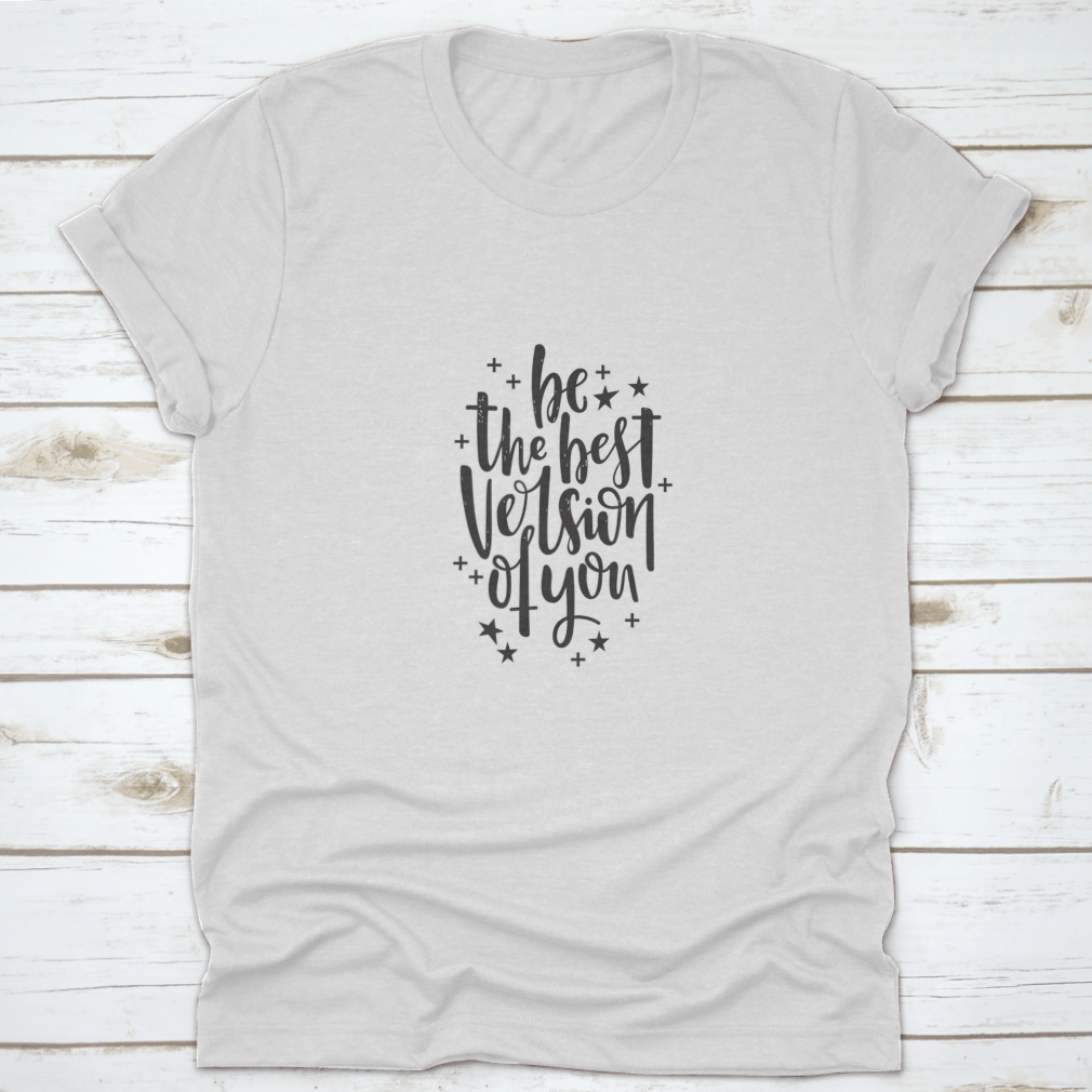 A stylish t-shirt featuring hand-drawn lettering that reads 'Be The Best Version Of You', made from soft cotton fabric.