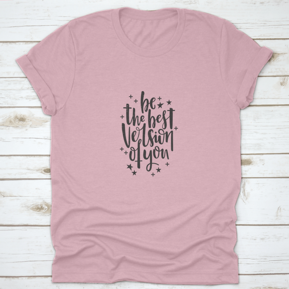 A stylish t-shirt featuring hand-drawn lettering that reads 'Be The Best Version Of You', made from soft cotton fabric.