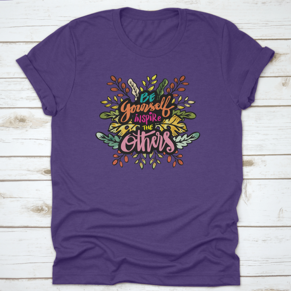 A stylish cotton t-shirt featuring motivational quotes 'Be Yourself Inspire Others' designed to uplift and inspire.