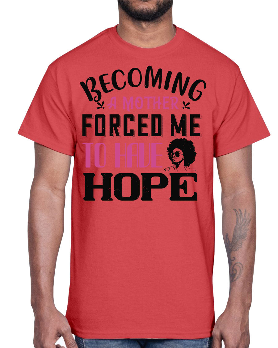 A stylish Afro Cotton Tee featuring the phrase 'Becoming a Mother Forced Me to Have Hope', showcasing its classic fit and soft fabric.