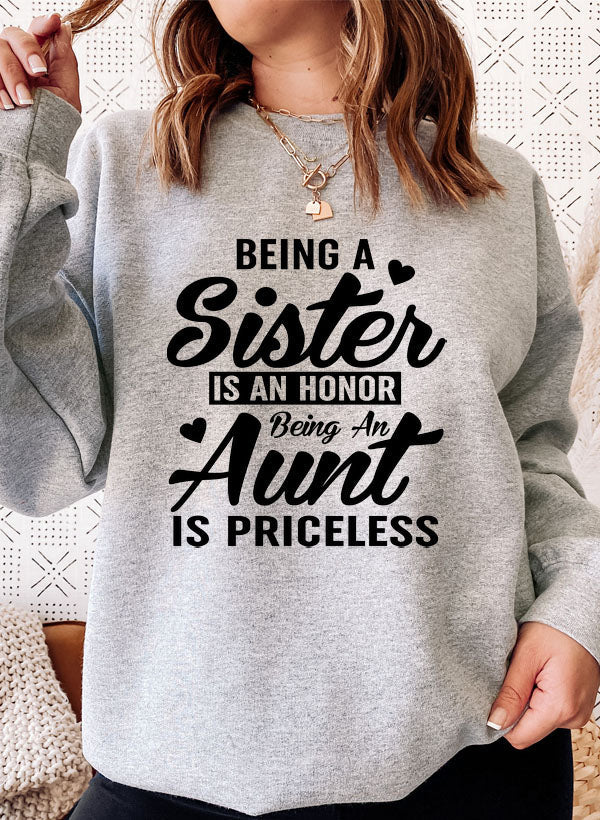 Cozy sweatshirt with the phrase 'Being A Sister Is An Honor Being An Aunt Is Priceless' designed for warmth and comfort.