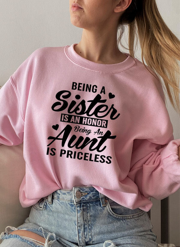 Cozy sweatshirt with the phrase 'Being A Sister Is An Honor Being An Aunt Is Priceless' designed for warmth and comfort.