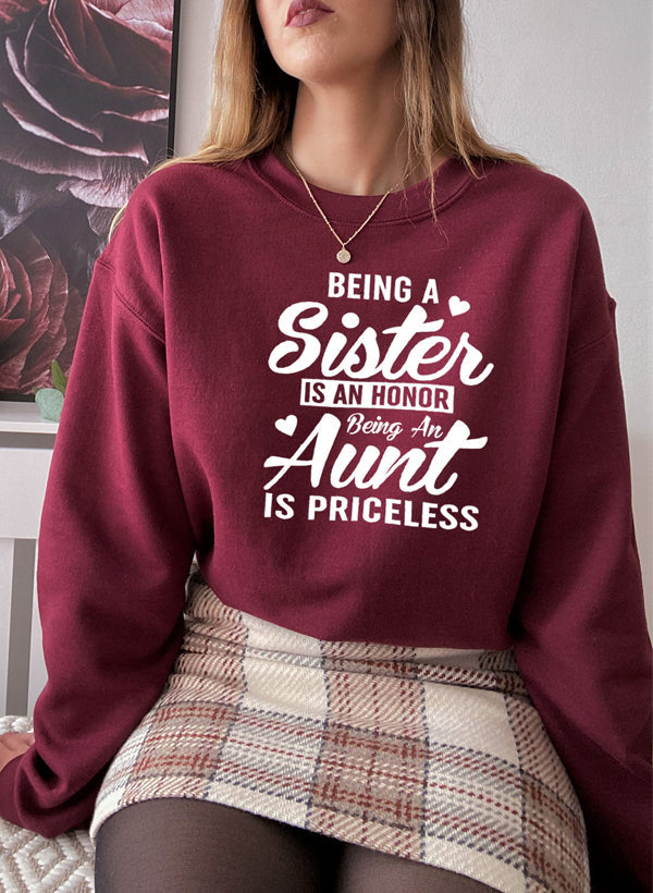 Cozy sweatshirt with the phrase 'Being A Sister Is An Honor Being An Aunt Is Priceless' designed for warmth and comfort.