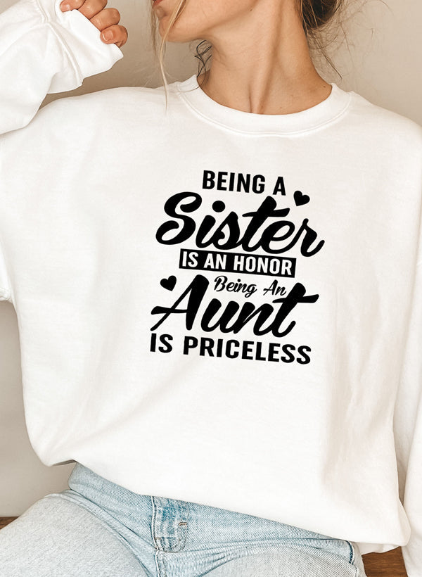 Cozy sweatshirt with the phrase 'Being A Sister Is An Honor Being An Aunt Is Priceless' designed for warmth and comfort.