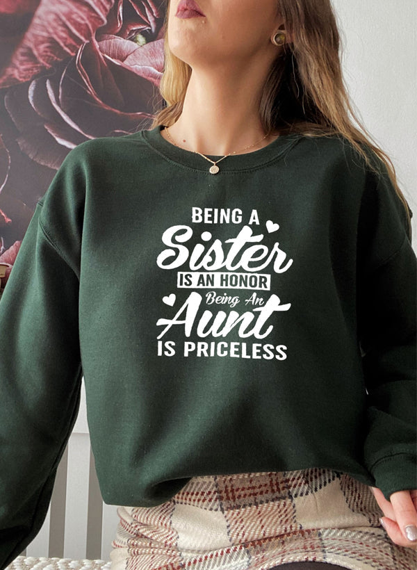 Cozy sweatshirt with the phrase 'Being A Sister Is An Honor Being An Aunt Is Priceless' designed for warmth and comfort.