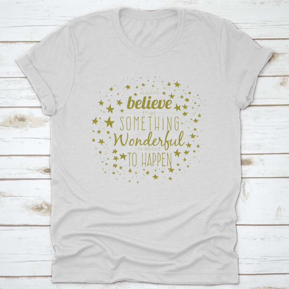 A stylish 'Believe Something Wonderful To Happen' T-shirt made from 100% cotton, featuring a classic fit and motivational design.