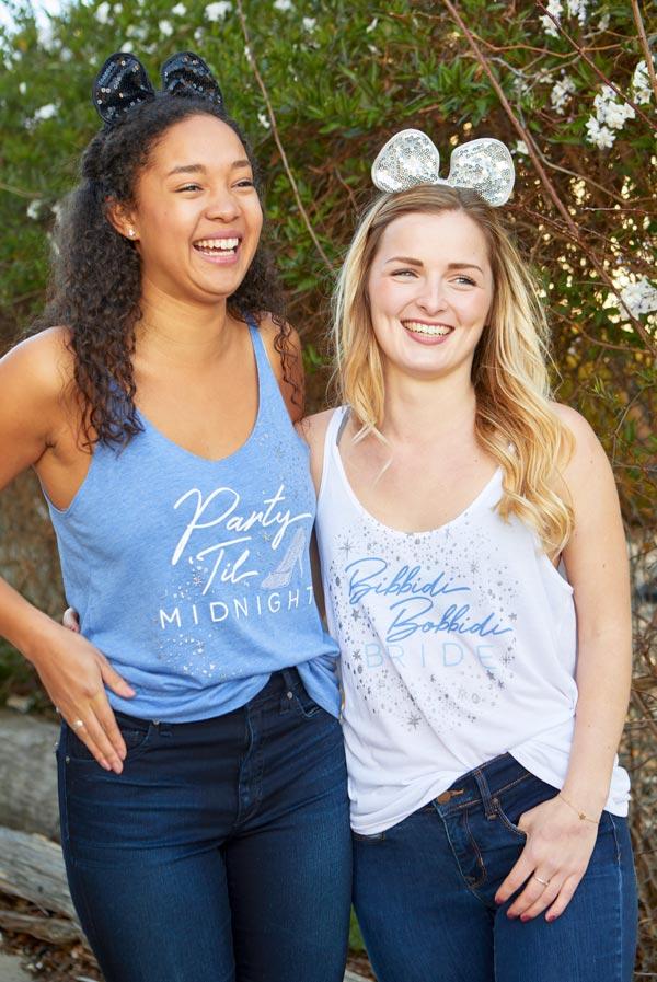 Bibbidi Bobbidi Bride tank top in white with sparkly lettering, and blue tank top with Party 'Til Midnight text, showcasing their flowy fit.