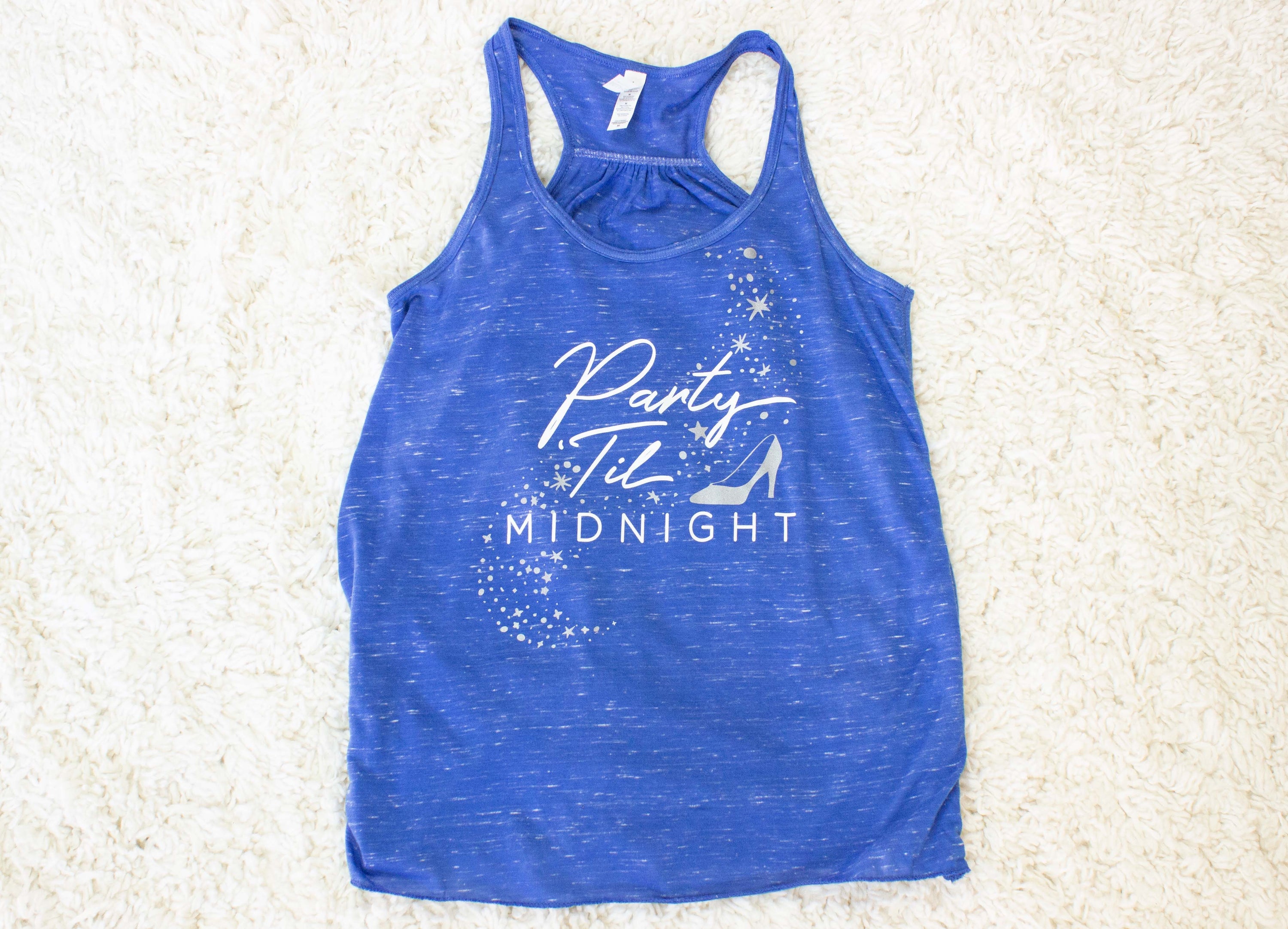 Bibbidi Bobbidi Bride tank top in white with sparkly lettering, and blue tank top with Party 'Til Midnight text, showcasing their flowy fit.