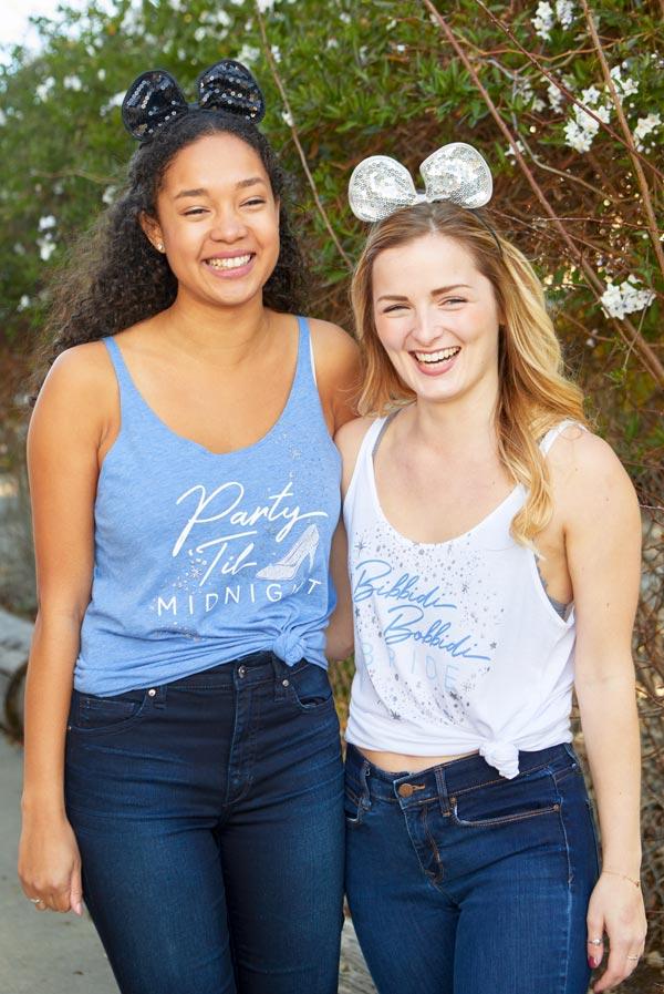 Bibbidi Bobbidi Bride tank top in white with sparkly lettering, and blue tank top with Party 'Til Midnight text, showcasing their flowy fit.