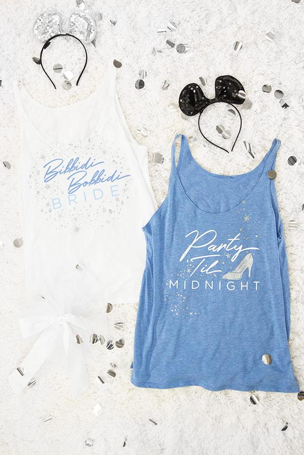 Bibbidi Bobbidi Bride tank top in white with sparkly lettering, and blue tank top with Party 'Til Midnight text, showcasing their flowy fit.