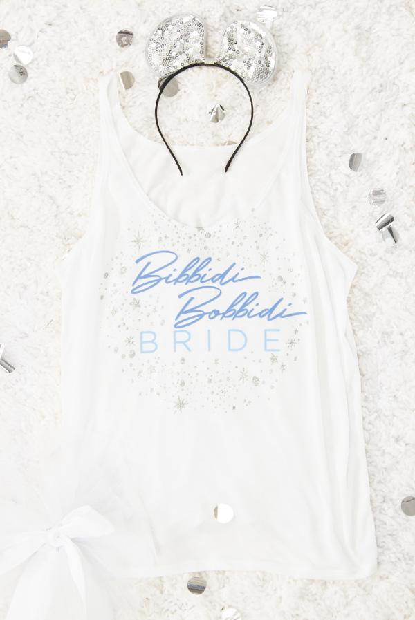 Bibbidi Bobbidi Bride tank top in white with sparkly lettering, and blue tank top with Party 'Til Midnight text, showcasing their flowy fit.