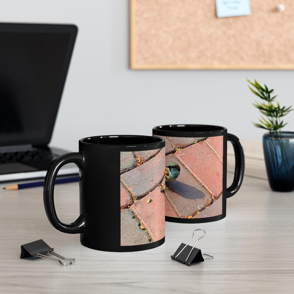 A sleek 11oz black ceramic mug with a C-handle, perfect for coffee, tea, or hot chocolate, showcasing customizable design options.