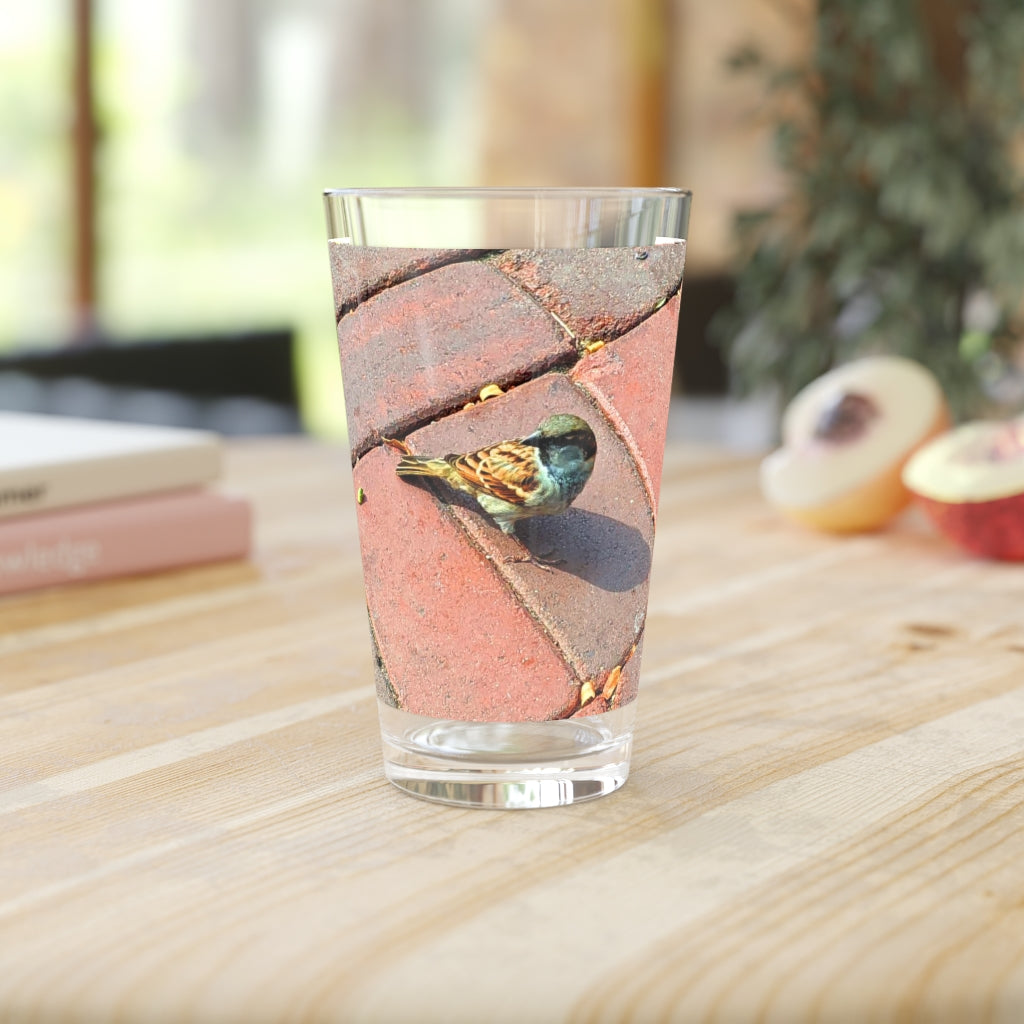 A clear 16oz Bird Pint Glass showcasing a custom printed design, perfect for beverages.