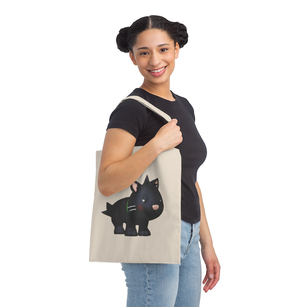 Black Kitty Canvas Tote Bag featuring a playful cat design, made from durable cotton sheeting with reinforced handles.