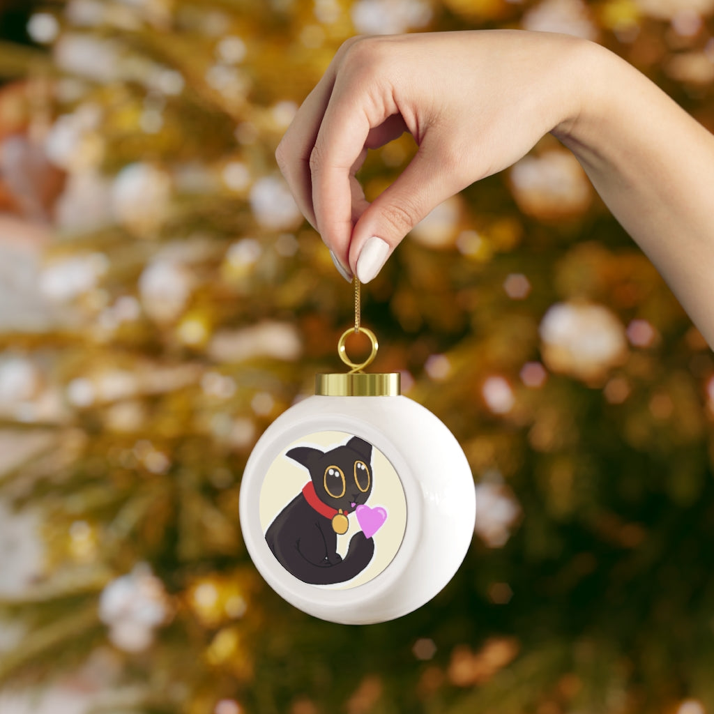 A glossy black Christmas ball ornament featuring a cute kitty design, adorned with a gold ribbon for hanging, perfect for holiday decor.