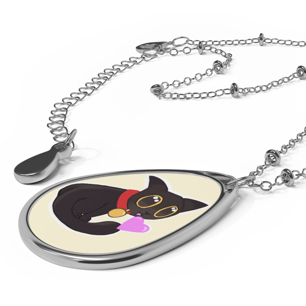 Black Kitty Oval Necklace featuring a unique ellipse-shaped brass pendant with a white print base and a lobster clasp closure.