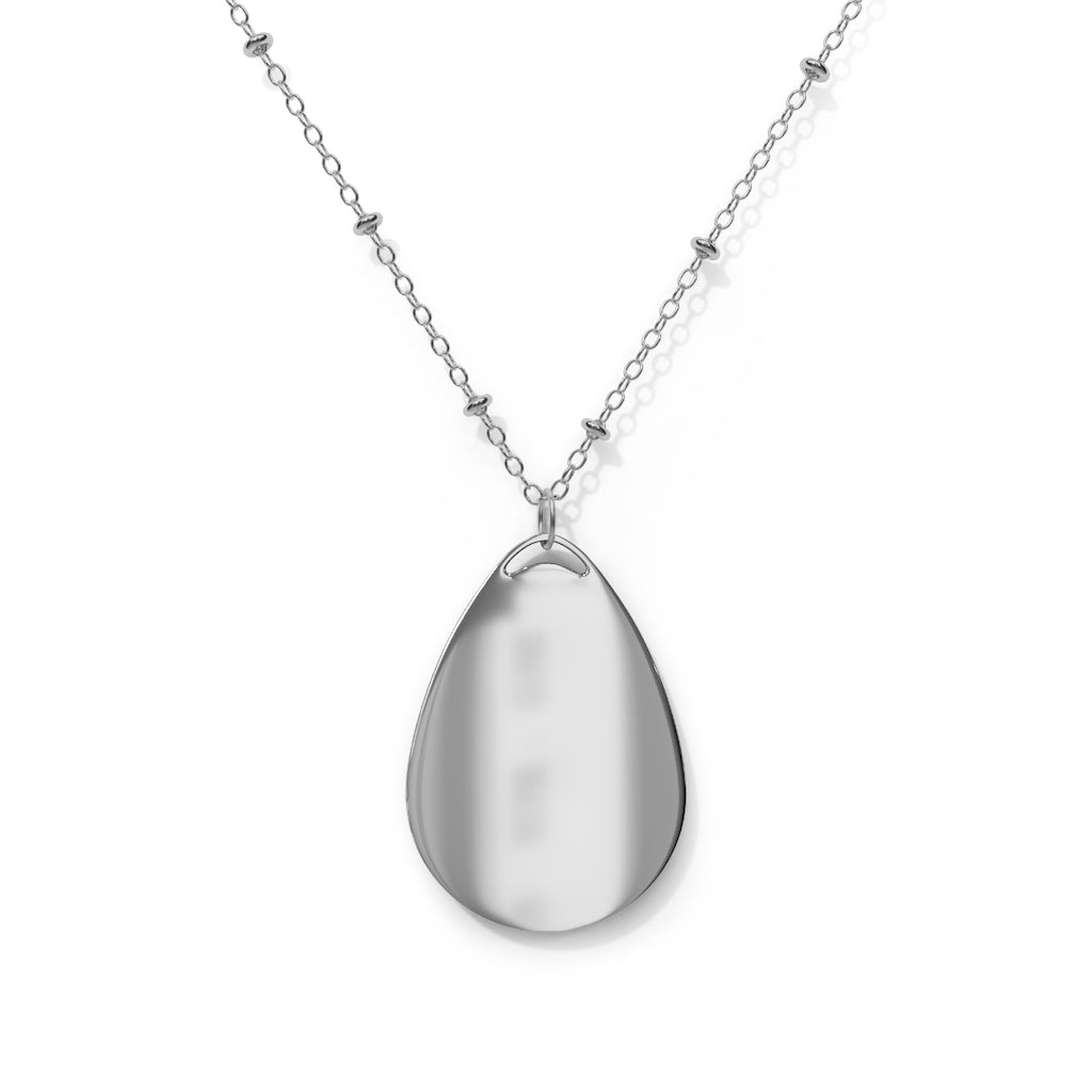 Blazeon Oval Necklace featuring a unique ellipse-shaped brass pendant and chain, showcasing a vibrant aluminum print panel.