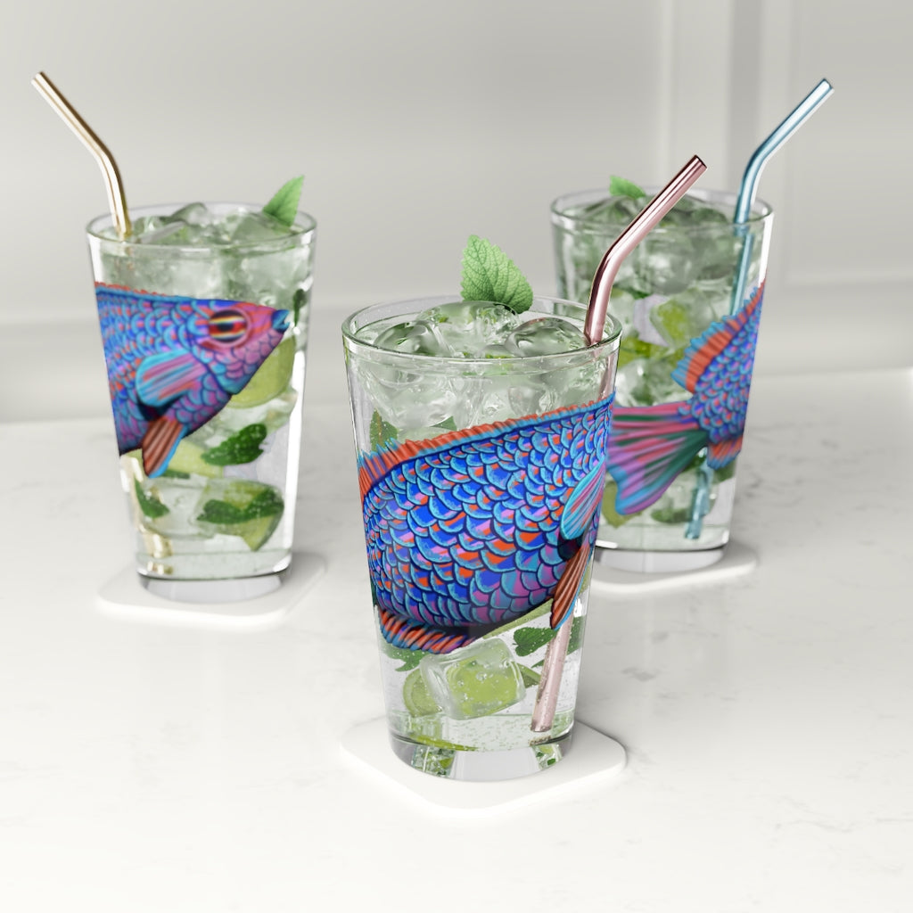 A clear 16oz pint glass featuring a vibrant blue and purple fish design, perfect for enjoying beverages.