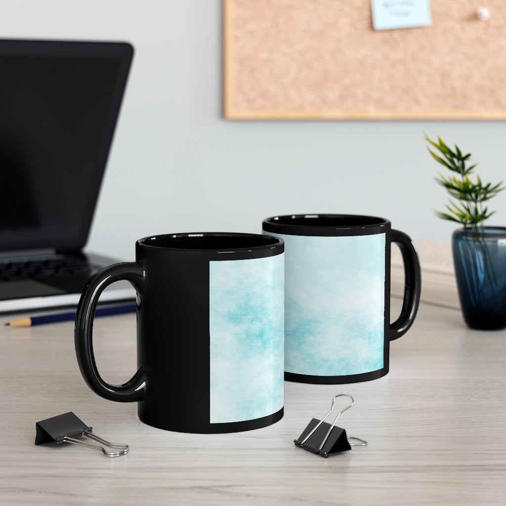 A stylish 11oz black ceramic mug featuring blue cloud designs, perfect for coffee, tea, or hot chocolate.