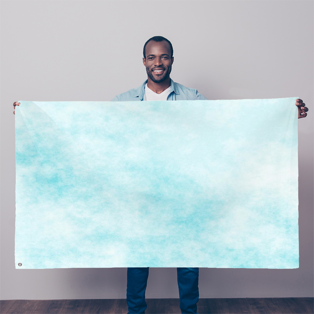 A vibrant Blue Clouds Sublimation Flag, measuring 5FT X 3FT, made from durable polyester fabric with double-stitched edges and eyelets for hanging.