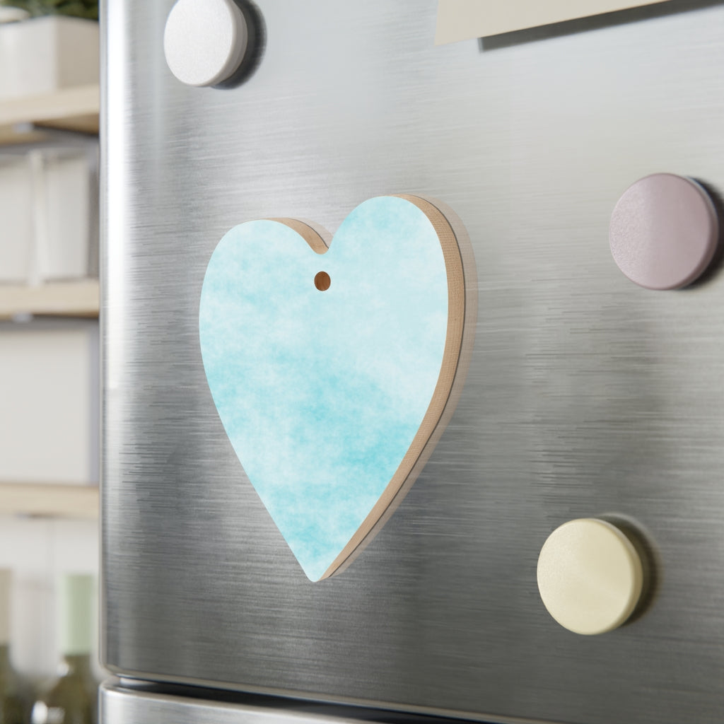 A collection of Blue Clouds Wooden Christmas Ornaments in various whimsical shapes, featuring a rustic wood finish and red ribbons for hanging.