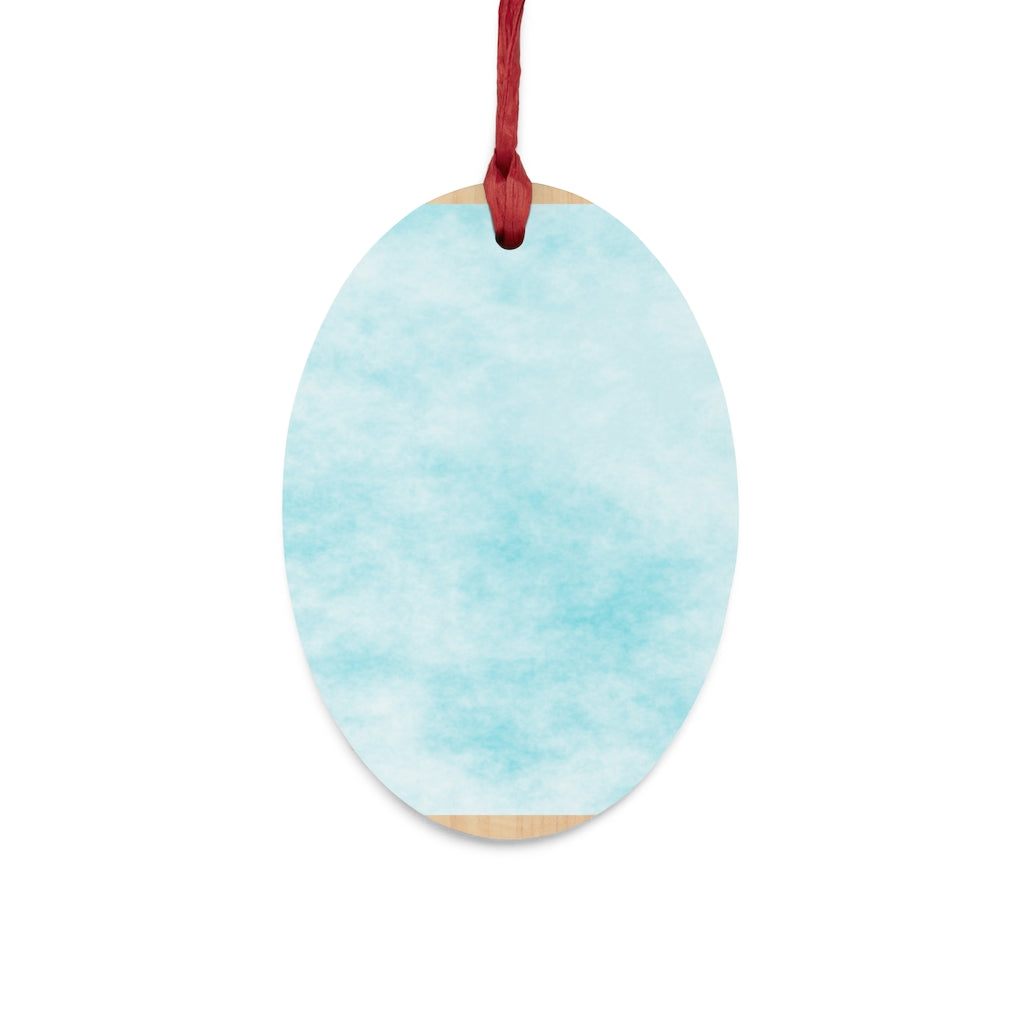 A collection of Blue Clouds Wooden Christmas Ornaments in various whimsical shapes, featuring a rustic wood finish and red ribbons for hanging.