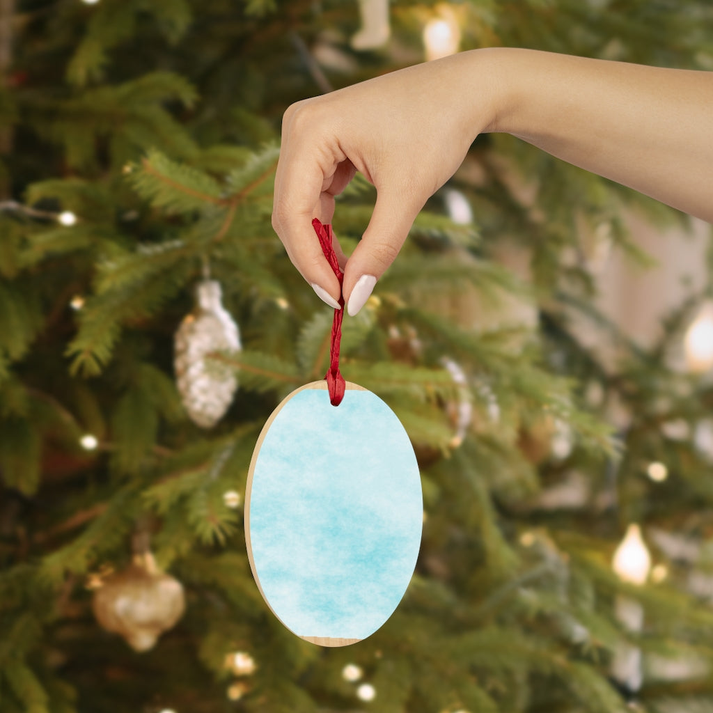 A collection of Blue Clouds Wooden Christmas Ornaments in various whimsical shapes, featuring a rustic wood finish and red ribbons for hanging.