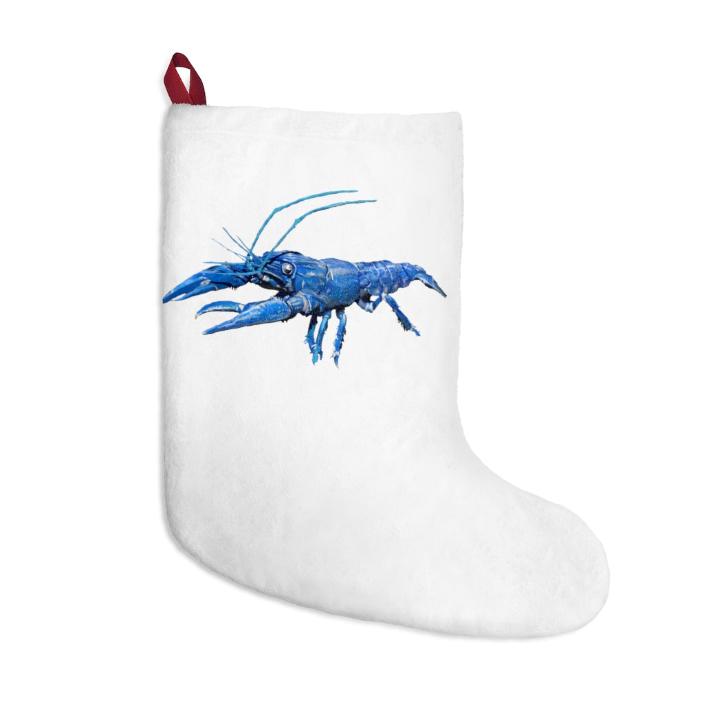 A cozy blue crawfish Christmas stocking hanging by a fireplace, featuring a soft fleece texture and a twill ribbon loop.