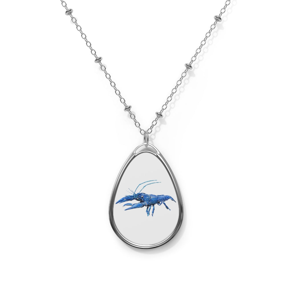 Blue Crawfish Oval Necklace featuring a unique ellipse-shaped brass pendant with a white print base and a secure lobster clasp closure.