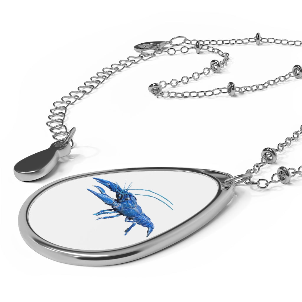 Blue Crawfish Oval Necklace featuring a unique ellipse-shaped brass pendant with a white print base and a secure lobster clasp closure.