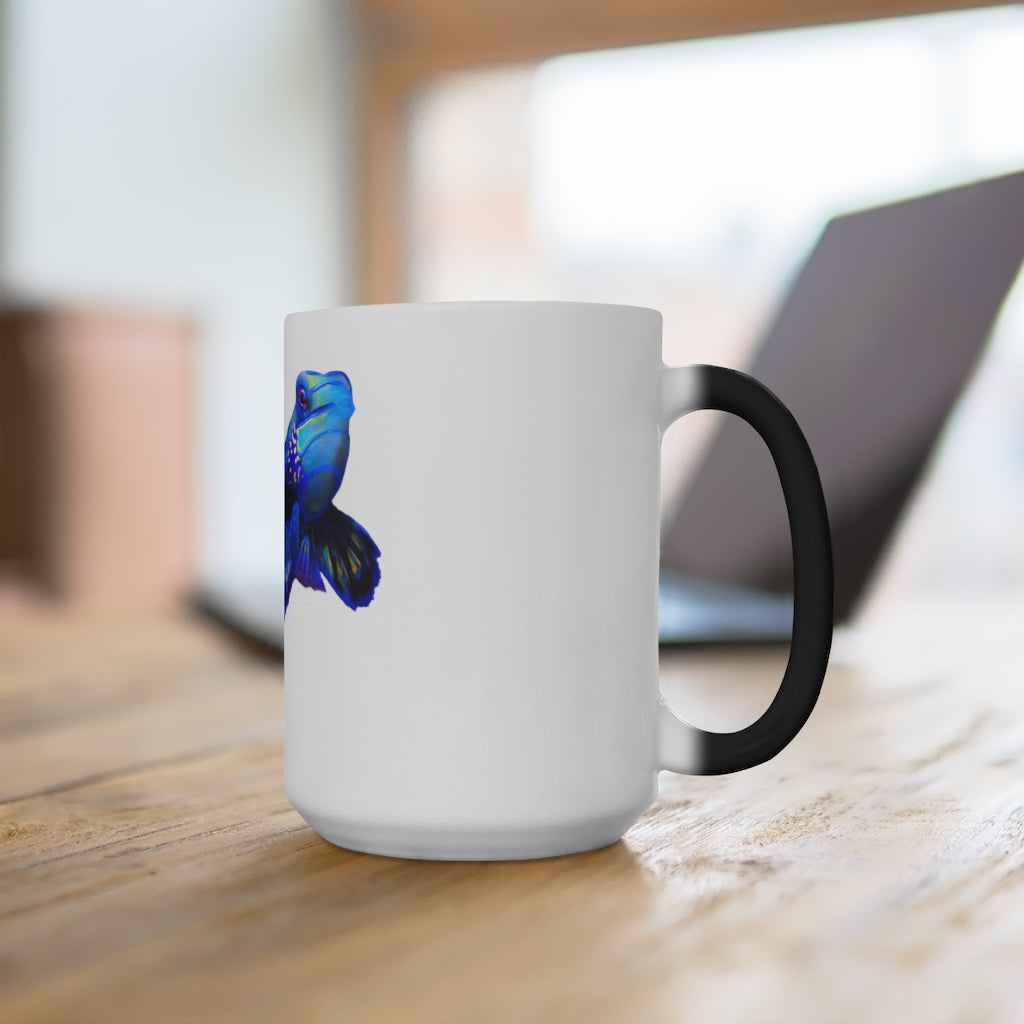 A blue fish color changing mug showcasing vibrant colors when filled with hot liquid, featuring a rounded design and C-handle.