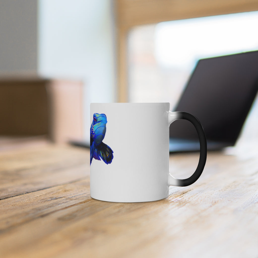 A blue fish color changing mug showcasing vibrant colors when filled with hot liquid, featuring a rounded design and C-handle.