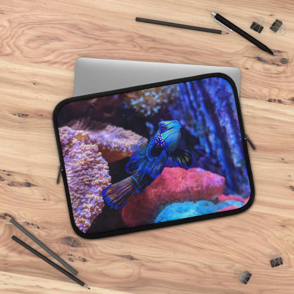 Blue Fish Laptop Sleeve featuring a vibrant fish design on the front and a solid black back, made from smooth neoprene material.